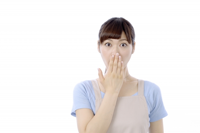 白い背景に、エプロンを着た前髪のある人が片手で口を覆い、驚いた表情をしています。彼らは、キャリアの中で別のポジションを模索することに伴うチャンスとリスクの組み合わせを体現しています。.